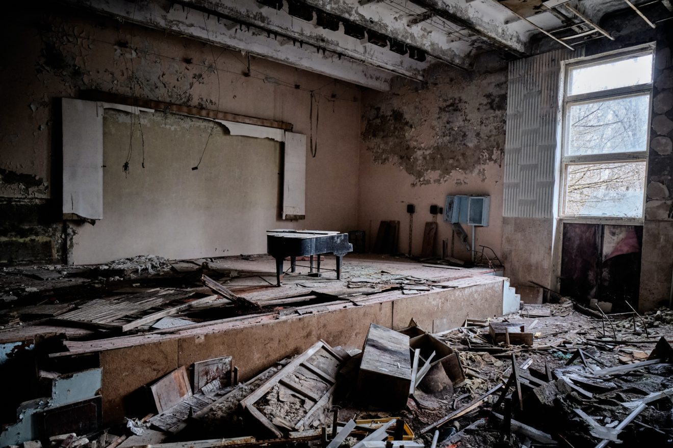 Amidst the ruins, a piano stands