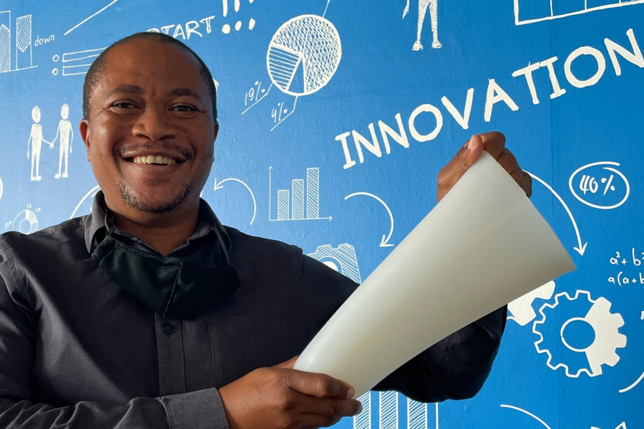 man holding amputees silicone socket liner blue wall in background innovation